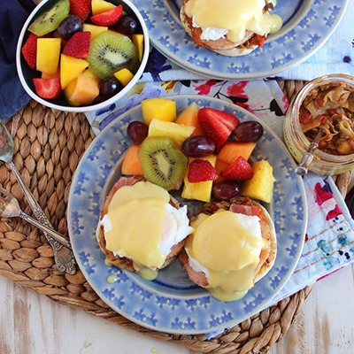 Eggs Benedict with artichokes and fruit.