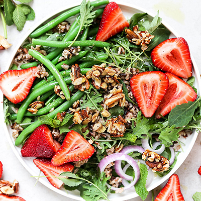 Strawberry recipes with a salad full of strawberries and nut clusters.