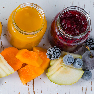 Colorful baby food purees in glass jars